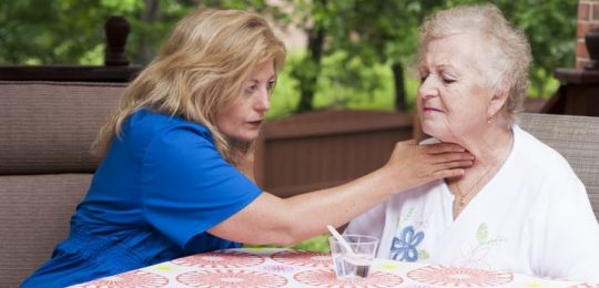 speech therapist working with elderly stroke patient