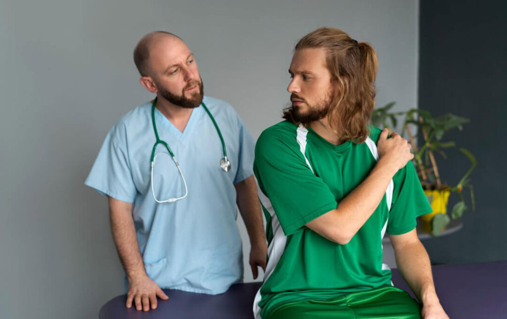 A medical professional assesses a patient experiencing shoulder discomfort, highlighting pain management and rehabilitation support in post-surgical care.
